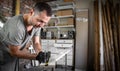 Carpenter holding a measuring tape on the work table Royalty Free Stock Photo