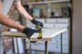 Carpenter holding a measuring tape on the work table Royalty Free Stock Photo