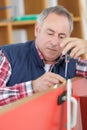 Carpenter installating a doorlock Royalty Free Stock Photo