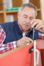 Carpenter installating a doorlock