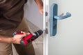 Carpenter Installing Door Lock