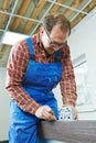 Carpenter installing door lock