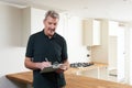 Carpenter Installing Luxury Fitted Kitchen Royalty Free Stock Photo