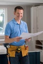 Portrait Of Carpenter Installing Luxury Fitted Kitchen Royalty Free Stock Photo