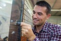 Carpenter installing new door knob with lock Royalty Free Stock Photo