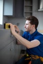 Carpenter Installing Luxury Modern Fitted Kitchen Royalty Free Stock Photo