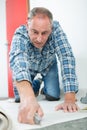 Carpenter joiner worker preparing door frame for indoor installation