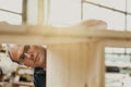 Carpenter or joiner working on a wooden cabinet in a workshop Royalty Free Stock Photo