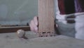 A carpenter joins two wooden parts made using the technology of a dovetail with a hammer. Detail of a carpenter with dovetail