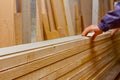 Carpenter lines up the glued wooden profiles in carpentry, preparing them for clamping