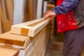 Carpenter lines up the glued wooden profiles in carpentry, preparing them for clamping