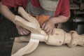 Carpenter makes a table with carved legs