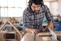 Carpenter making precision cuts to wood using a table saw