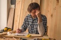 Carpenter making woodwork project notes on clipboard paper