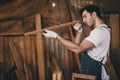 Carpenter man attend to making masterpiece woodworks handcrafted fine detail make wooden furniture in wood workshop