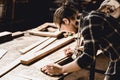 Carpenter man making masterpiece woodworks handcraft furniture in wood workshop