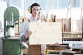 Carpenter man show the wooden placard isolated in carpentry background Royalty Free Stock Photo