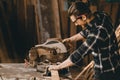Carpenter man using Electric Wood Cutter woodcraft working in furniture wood workshop with professional skill real people workman. Royalty Free Stock Photo