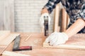 Carpenter Man is Working Timber Woodworking in Carpentry Shop, Craftsman is Hammering a Nail into Timber Frame for Wooden