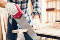 Carpenter Man is Working Timber Woodworking in Carpentry Shop, Craftsman is Saw Cutting Timber Frame for Wooden Furniture in