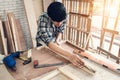 Carpenter Man is Working Timber Woodworking in Carpentry Shop, DIY Craftsman is Measuring Tape Furniture Wood in Workshop. Male Royalty Free Stock Photo