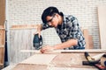 Carpenter Man is Working Timber Woodworking in Carpentry Workshops, Craftsman is Measuring Timber Frame for Wooden Furniture in