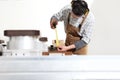 Carpenter man works with wooden planks in the joinery, measure with meter, with computer numerical control center, cnc machine,