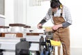 Carpenter man works with wooden planks in the joinery, measure with meter, with computer numerical control center, cnc machine,