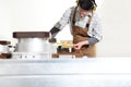 Carpenter man works with wooden planks in the joinery, measure with meter, with computer numerical control center, cnc machine,