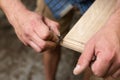 The carpenter manually sanded the corner of the oak panel with sandpaper closeup Royalty Free Stock Photo