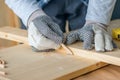 Carpenter marking pine wood plank for cutting Royalty Free Stock Photo