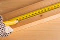 Carpenter marking pine wood plank for cutting Royalty Free Stock Photo