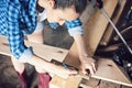 Carpenter marks the cut line on a wooden Board with a pencil and a corner, close-up