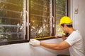 Carpenter measures the glass pane for renovation.