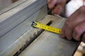 Carpenter measuring the cutting area of circular saw Royalty Free Stock Photo