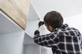 Carpenter measuring shelves that are parts of new kitchen with meter Royalty Free Stock Photo