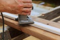 Carpenter milled wood upper hand electric router Royalty Free Stock Photo