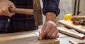 Carpenter nail wood. DIY, home repair and fix. Male hand hold hammer and nail