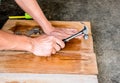 The Carpenter nailing wood board to make furniture