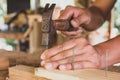 The carpenter is nailing the wood in the workshop Royalty Free Stock Photo