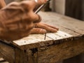 Carpenter nailing in a wooden surface stock footage.