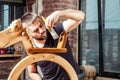 Carpenter paints children`s wooden toy