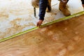 Carpenter with pencil in his hand measures the cutting board a tape measure Royalty Free Stock Photo