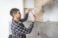 The carpenter places the handles and screws them with a screwdriver