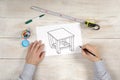 carpenter draws a sketch of furniture for manufacturing. pencil in hand Royalty Free Stock Photo