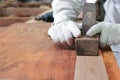 Carpenter planing a plank of wood using a hand planer in carpentry workshop. Royalty Free Stock Photo