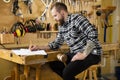 Carpenter planning new work in the workshop