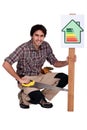 Carpenter promoting energy savings. Royalty Free Stock Photo