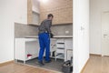 A carpenter sets up a working surface in the kitchen