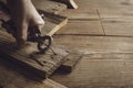Carpenter removing rusty nails from old wooden planks